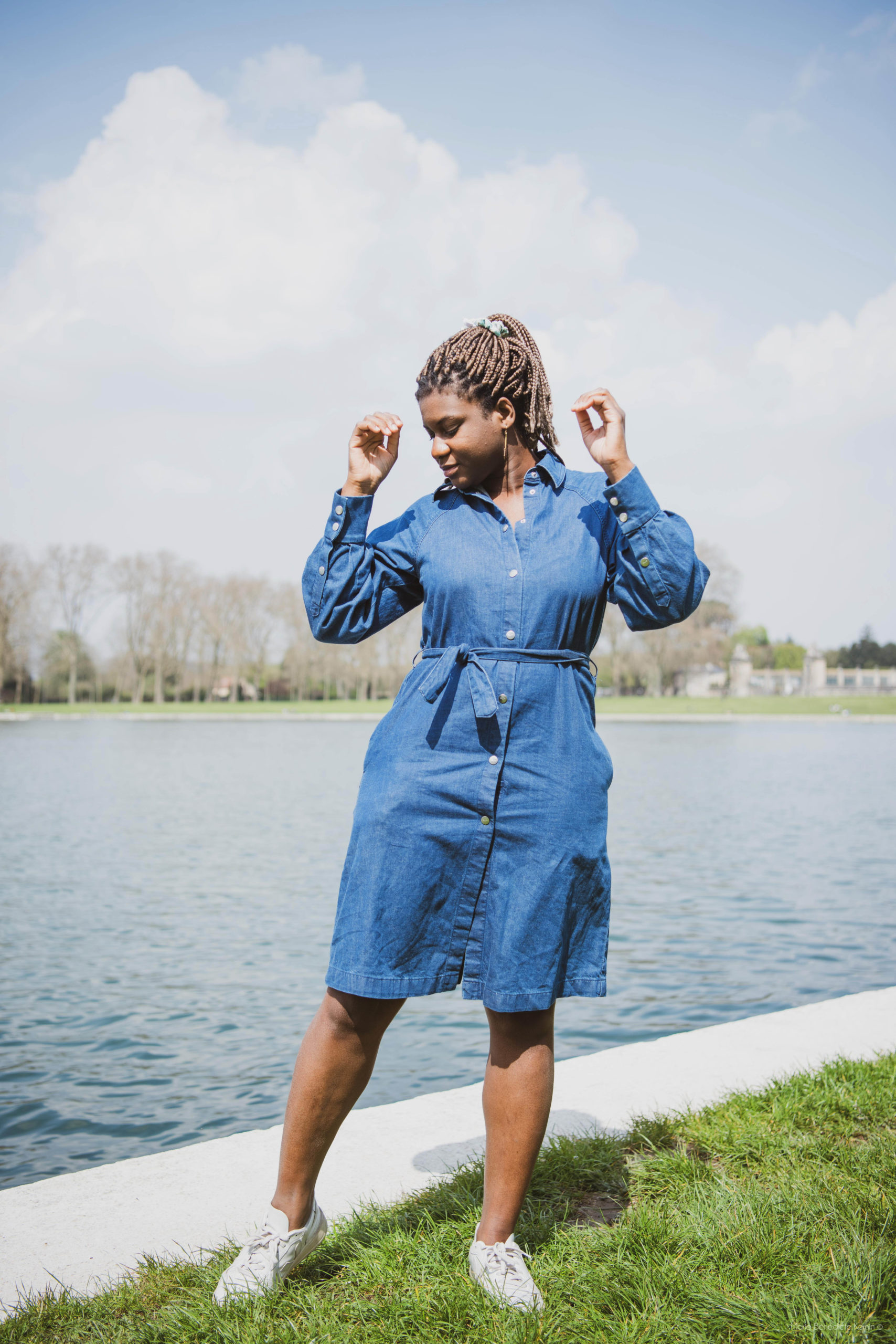 Adelana standing by the lake with a blue Denim Dress